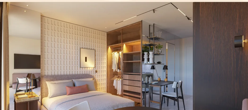 Render do quarto integrado do studio de 28 m² do Vibe Meireles, com cama, marcenaria e escrivaninha